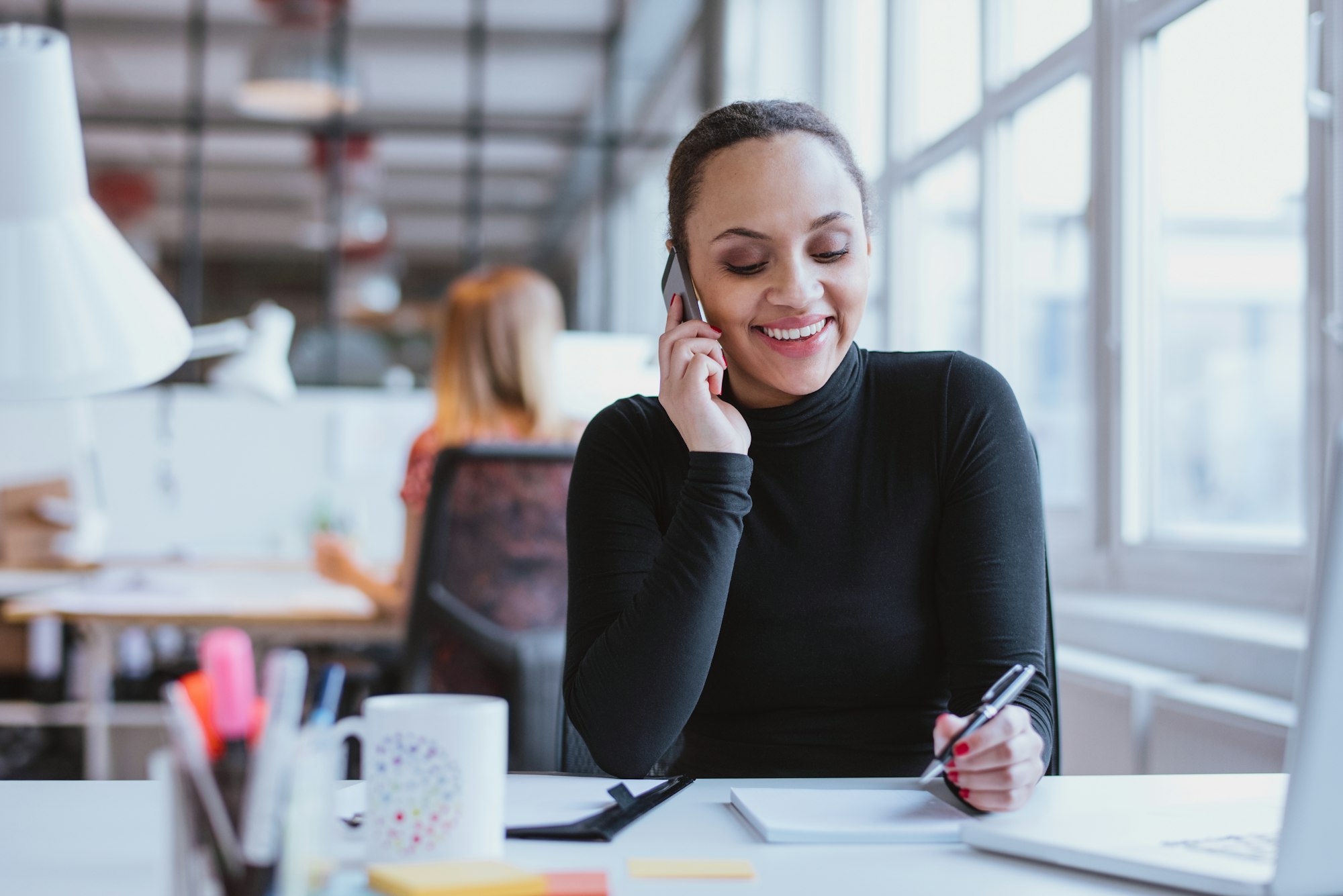 Woman answering a phone call while at work